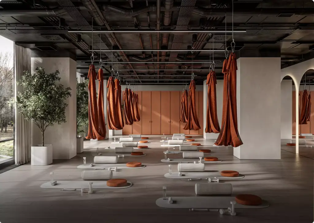 3D interior rendering of yoga studio with hanging fabric hammocks, mats, cushions, open industrial ceiling