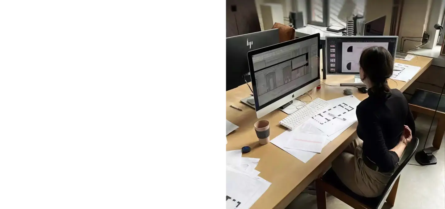 Designer at desk using 3Ds Max on dual monitors with plans, 3Ds Max a legend or a versatile software