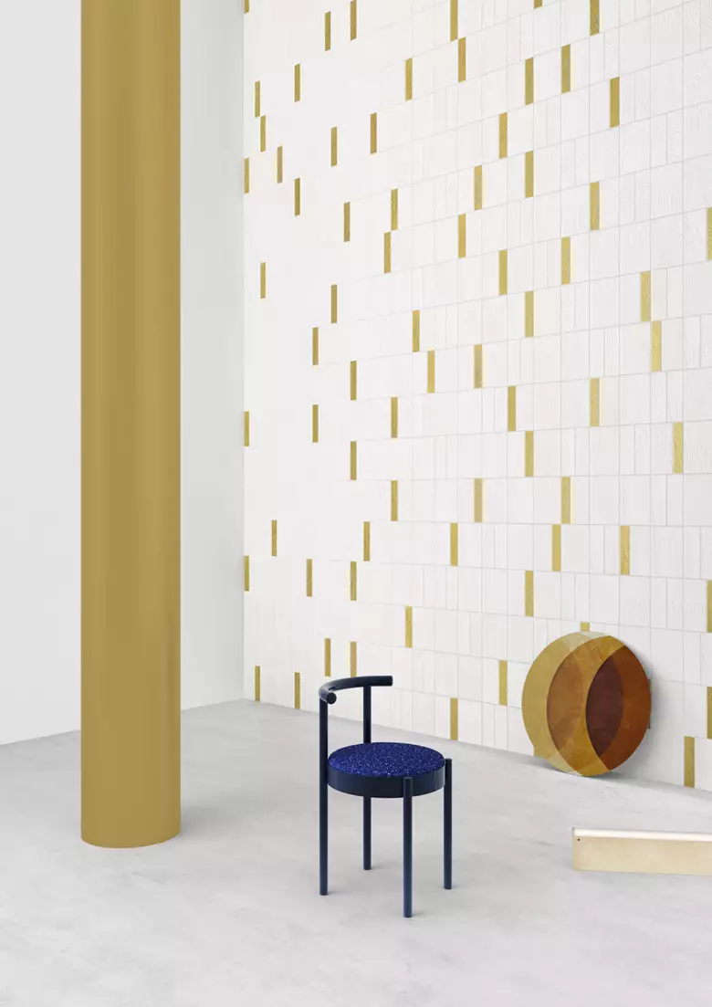 Best 3D Rendering Studios in Italy for 2026 Minimal 3D rendered interior in Italy with white tile wall, gold accents, and blue chair