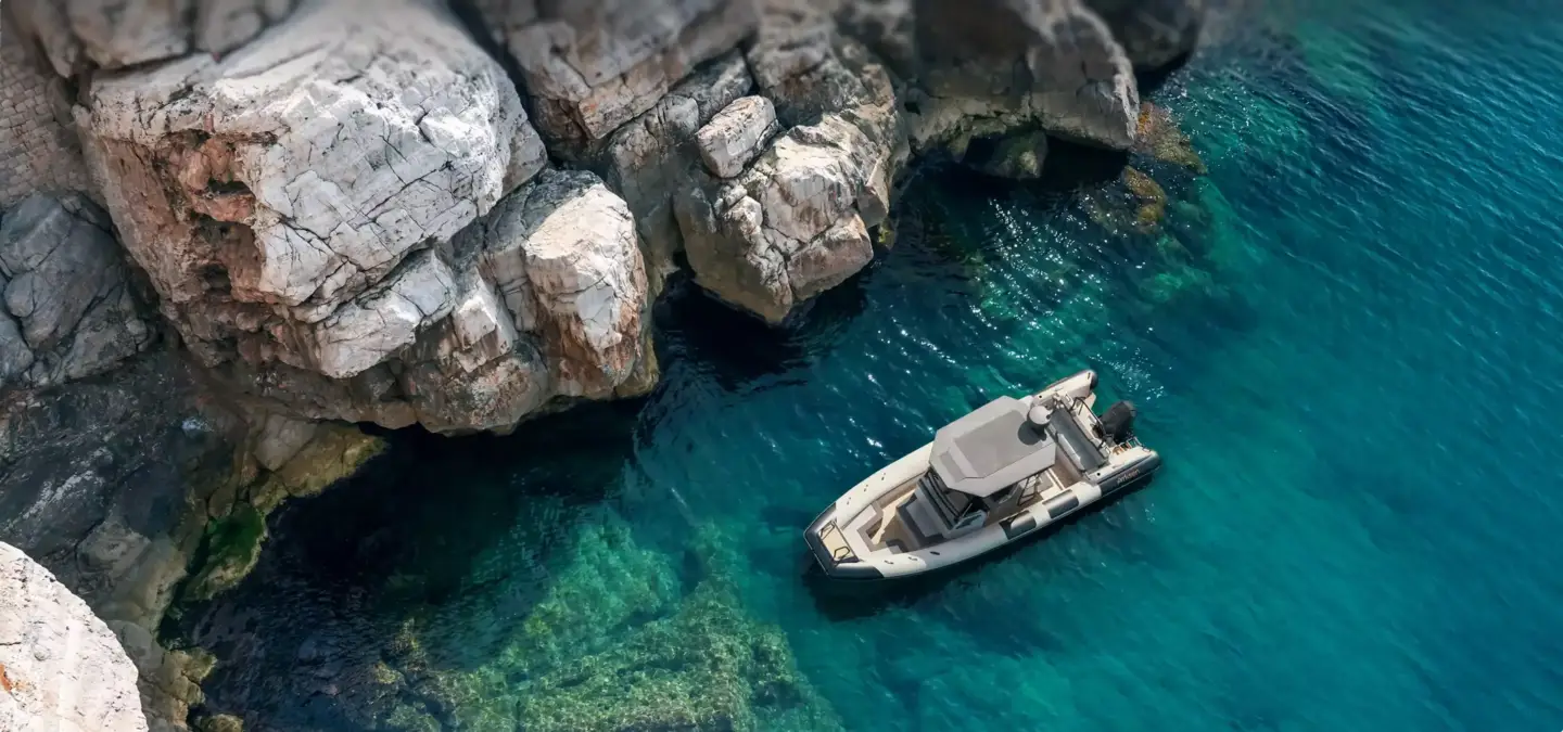 Motor yacht floating in turquoise water by cliffs, best yacht visualization and 3D renders