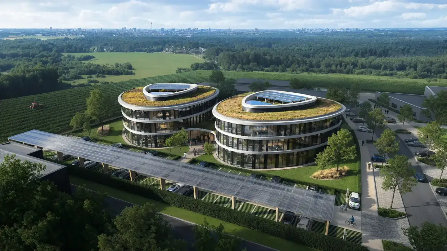 Best 3D Rendering Companies in Germany Aerial view of two curved modern office buildings with green roofs, solar panels, and landscaped surroundings