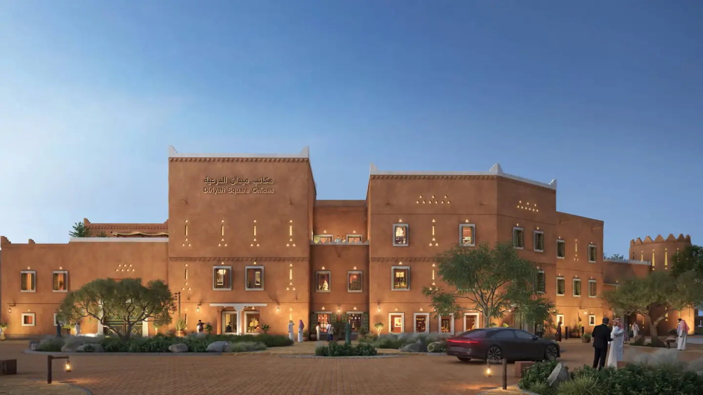 Best 3D Rendering Companies in Saudi Arabia Diriyah Square Offices traditional facade at dusk with illuminated windows and visitors outside
