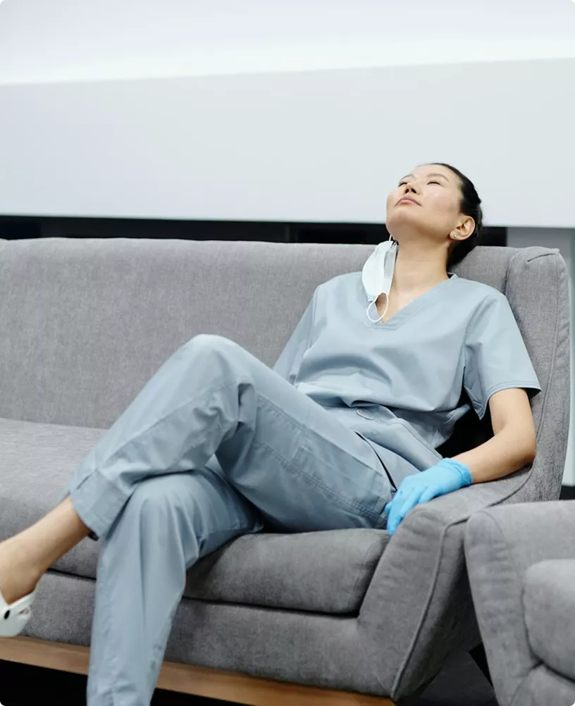 Nurse resting on a sofa, visual from the home nurse app presentation