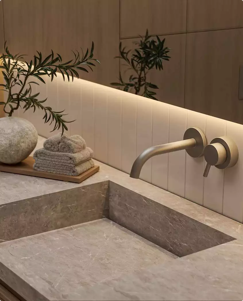 3D tour apartments bathroom sink detail with stone basin, wall faucet, folded towels, and soft lighting