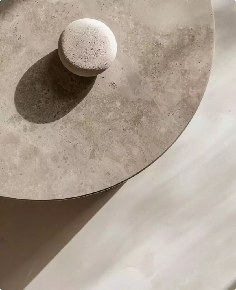 Cafe visualization with a round stone surface, textured knob, and soft shadow in neutral tones