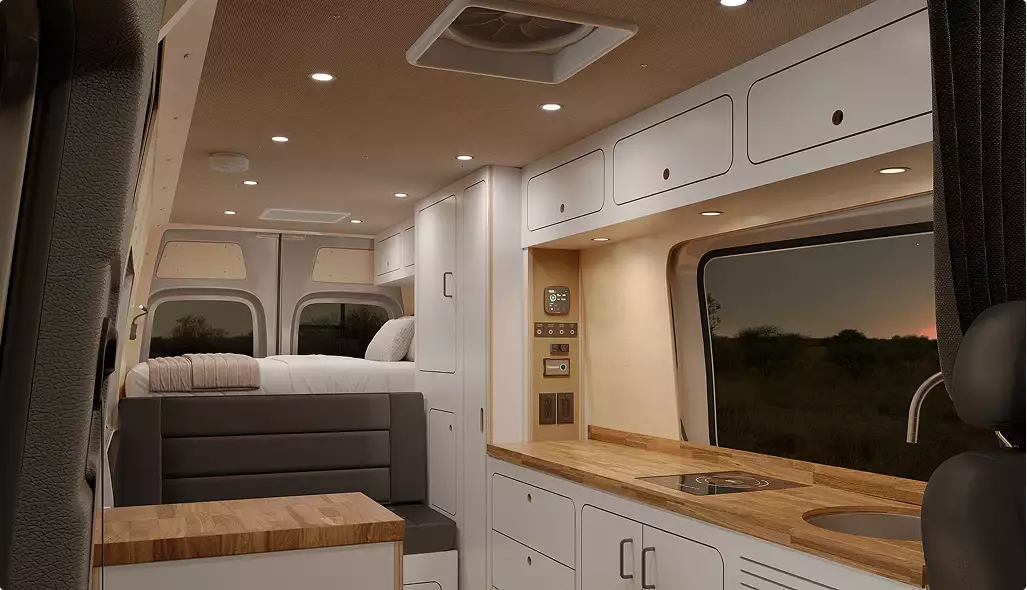 campervan interior ideas with raised bed, kitchen counter, sink, cooktop and overhead cabinets with lighting