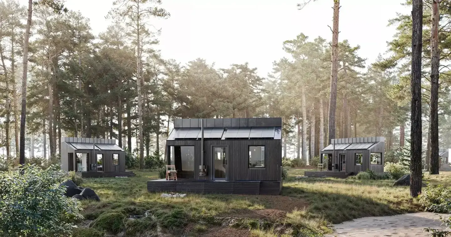 What Is Contemporary Architecture: The Design Language Shaping Iconic Buildings Contemporary architecture black cabins in a pine forest clearing, with decks and tall trees