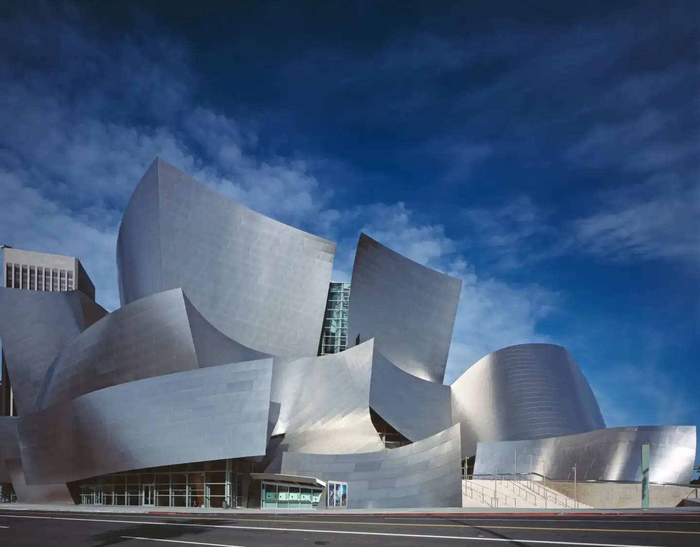 What Is Contemporary Architecture: The Design Language Shaping Iconic Buildings Contemporary architecture silver sculptural building under a blue sky, with curved metal forms