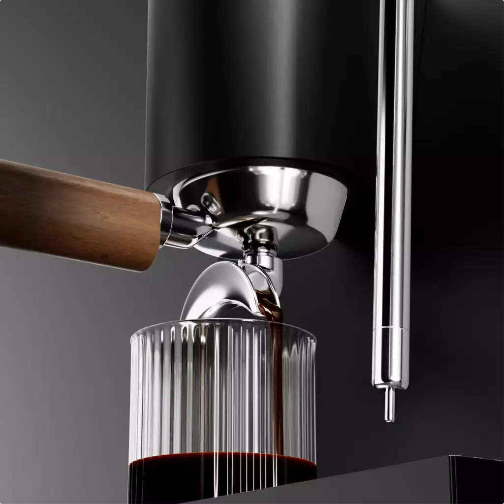 Espresso flowing from chrome spout into ribbed glass under black machine with wooden handle