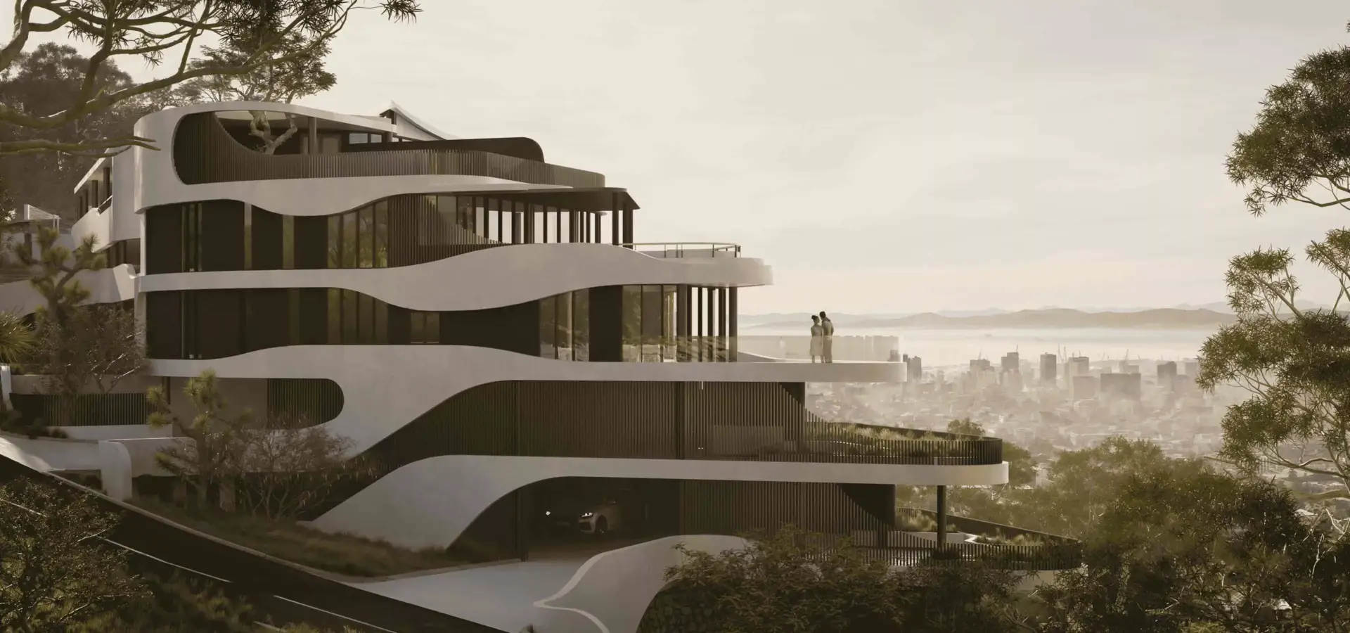 Hotel exterior of a modern hillside tower with curved terraces, glass walls, trees, and city skyline view
