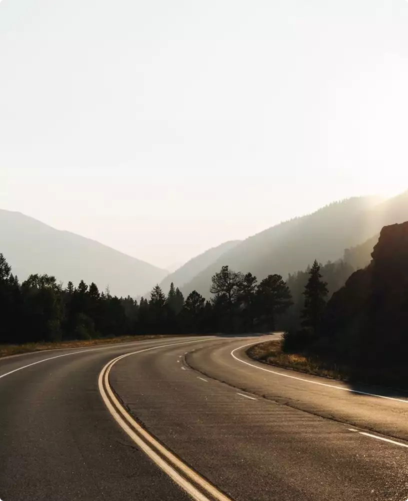 interior design campervan inspiration scenic mountain road through forest valley at sunrise