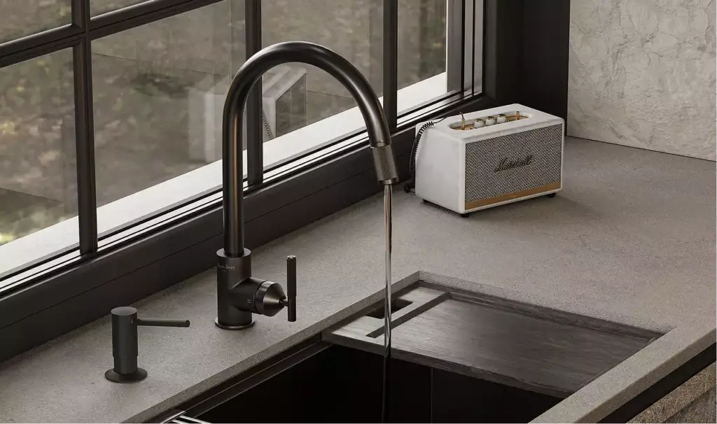 Interior modular homes kitchen sink with black faucet, stone counter, window, and speaker