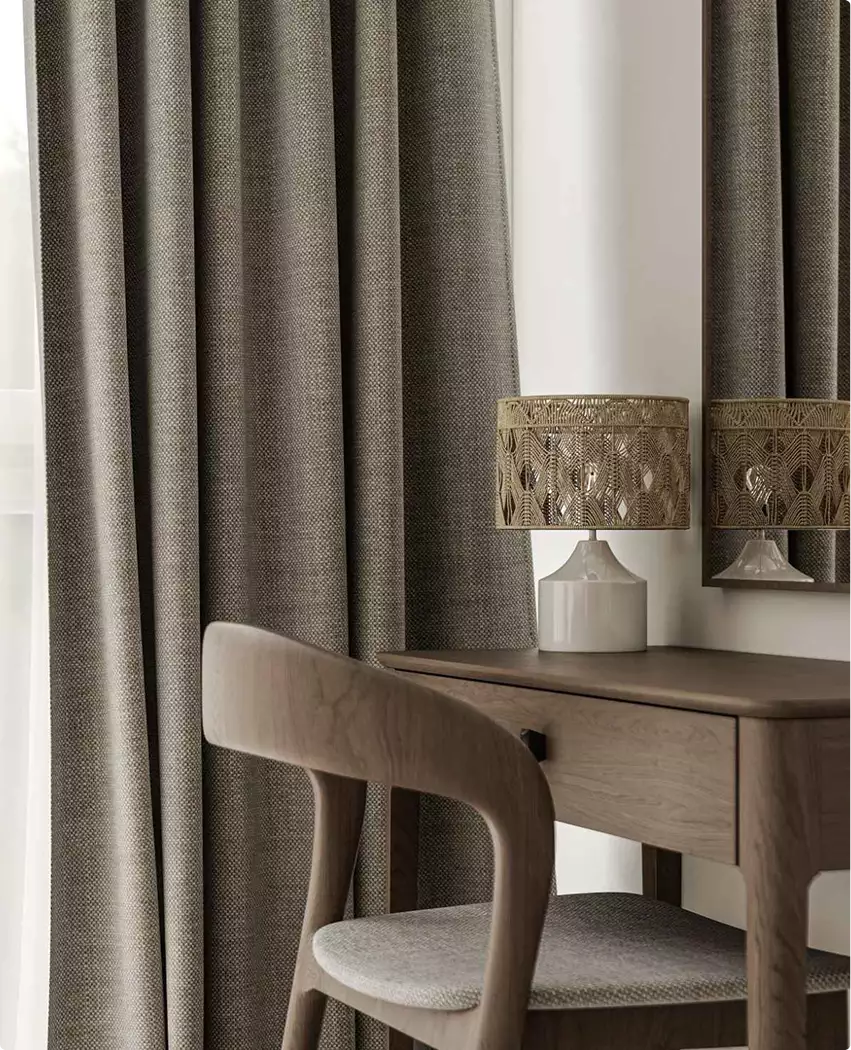 Luxury apartments 3D tour vanity with wood desk, cushioned chair, table lamp, and textured curtains