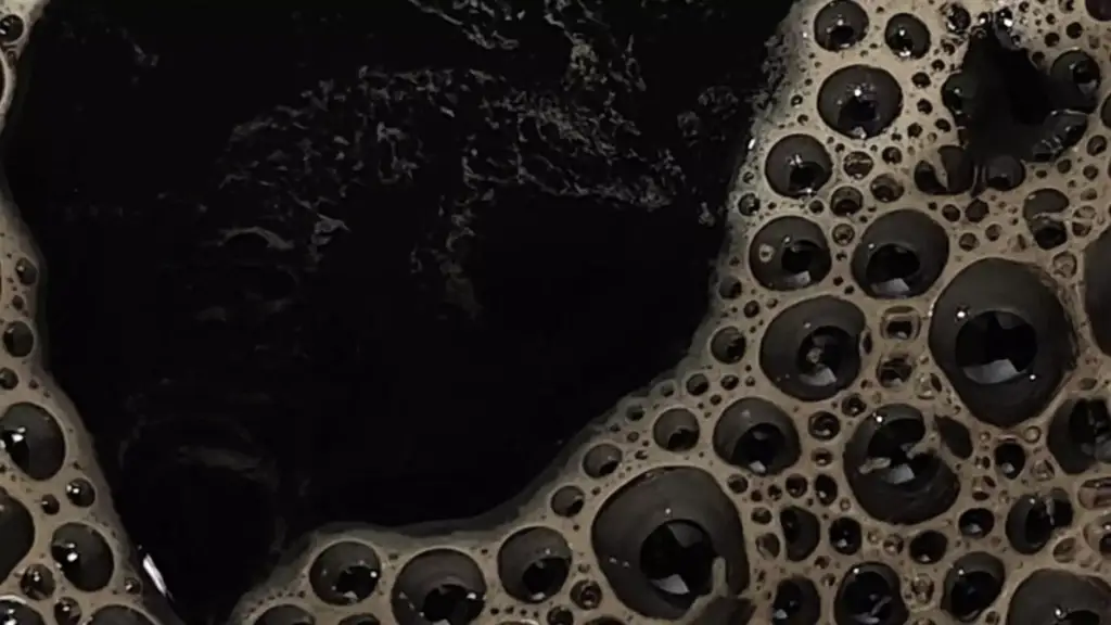 Macro coffee surface with dense bubbles as abstract espresso product design detail