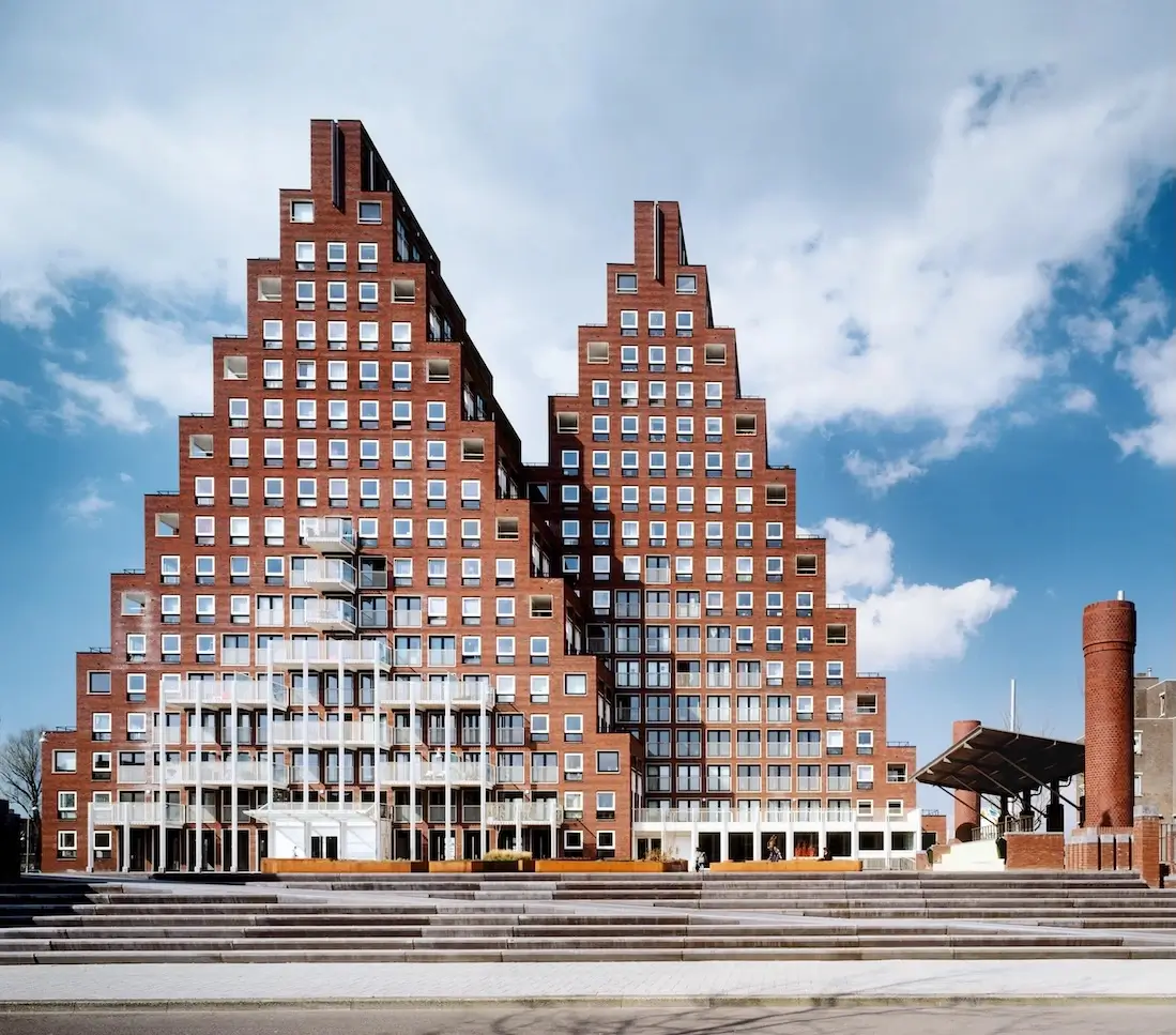 Architectural Styles Through History: 15 Types and How to Identify Them Postmodern architectural style stepped brick building with geometric facade and modern urban plaza