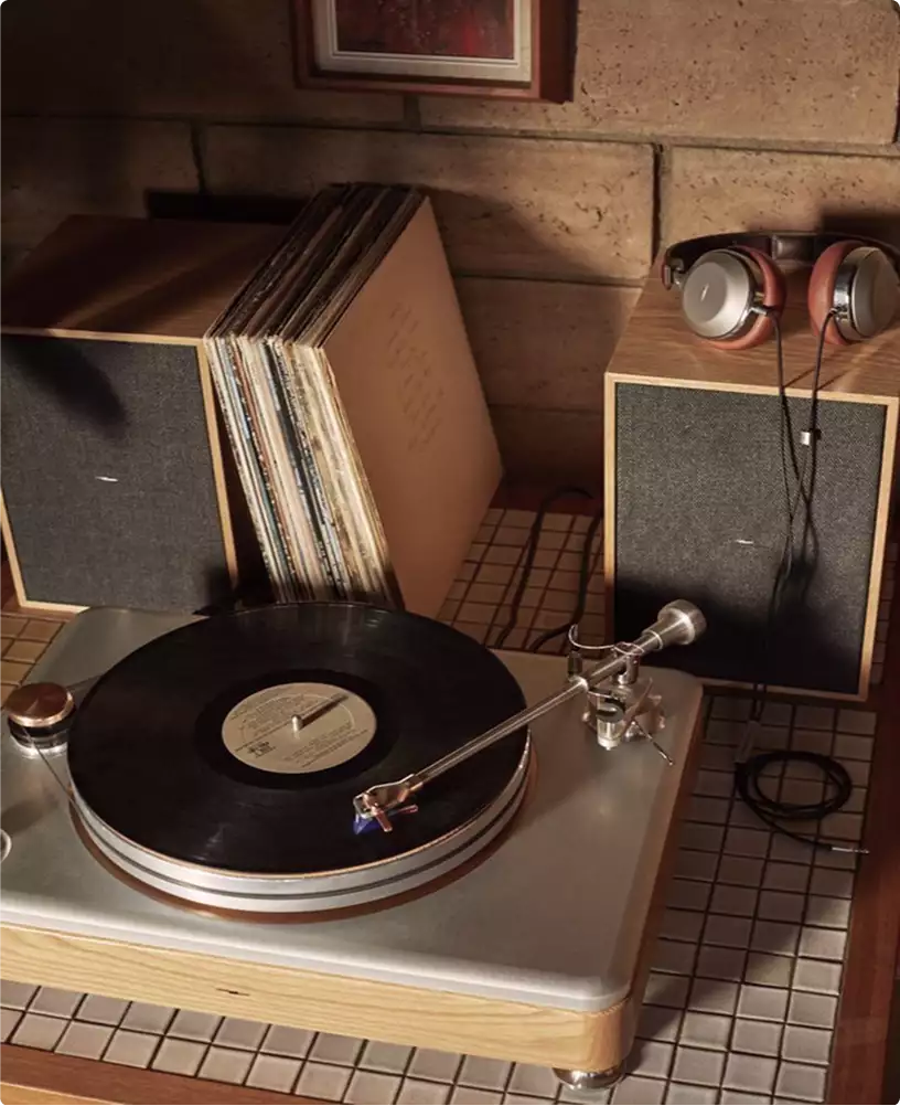 Product rendering service example showing vinyl turntable with record, speakers, headphones, and vinyl albums
