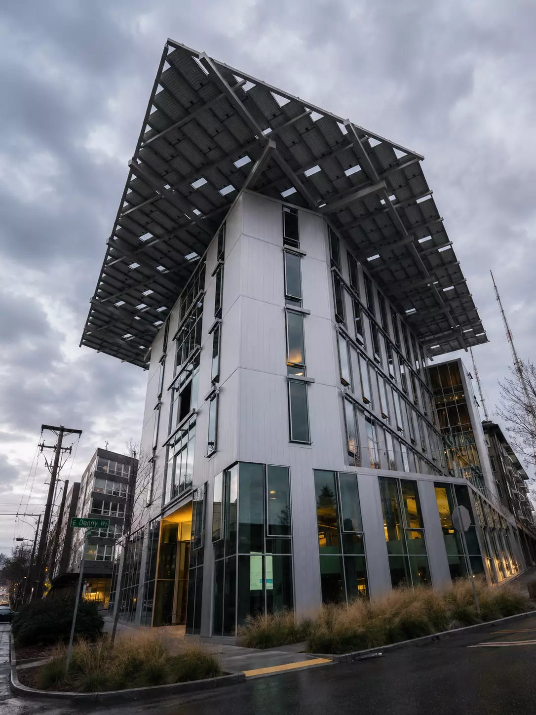 What Is Green Architecture? Meaning, Principles, and Examples Urban green building with a large solar canopy above glass walls