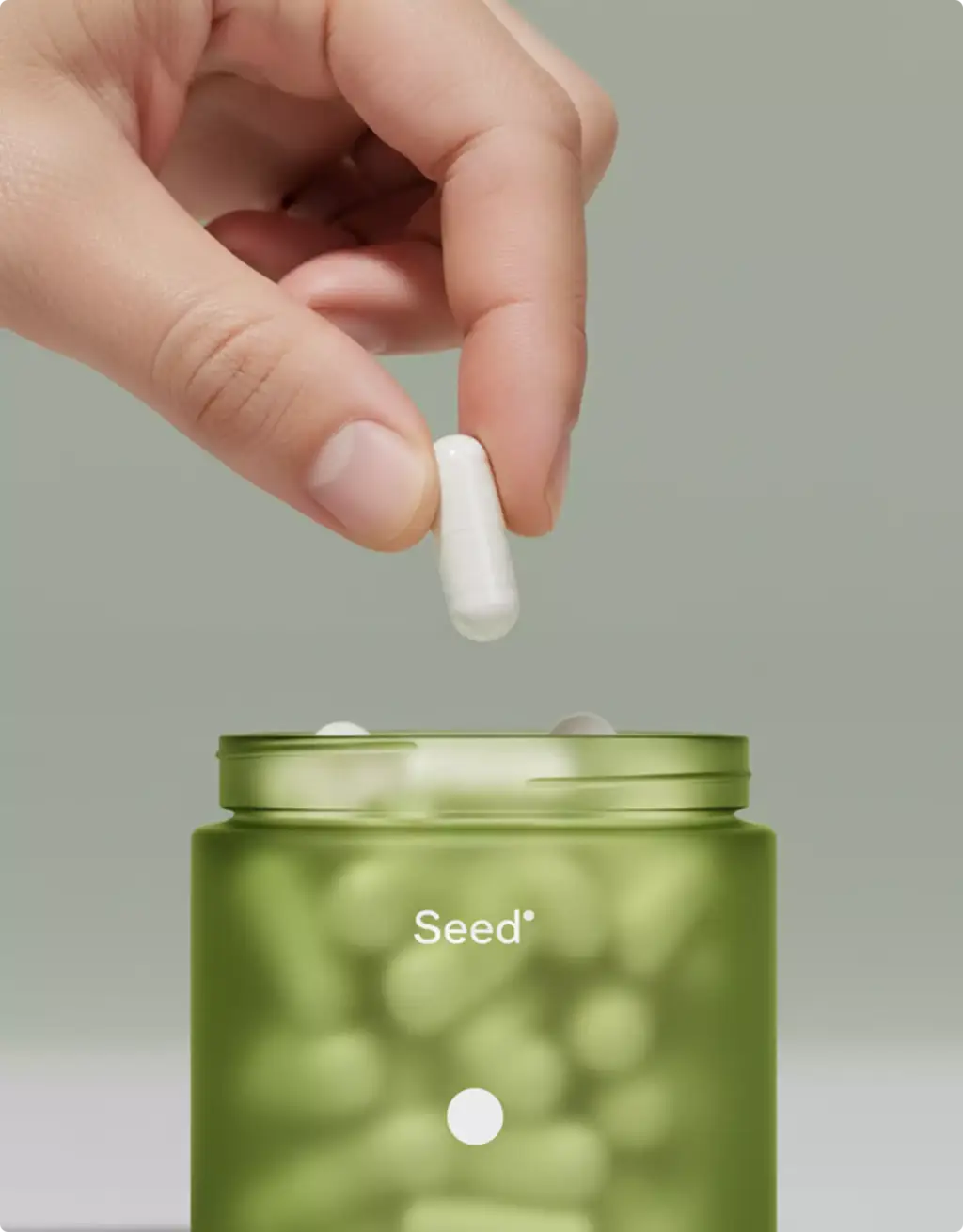 Capsule dropping into green supplement bottle render created using product modeling services