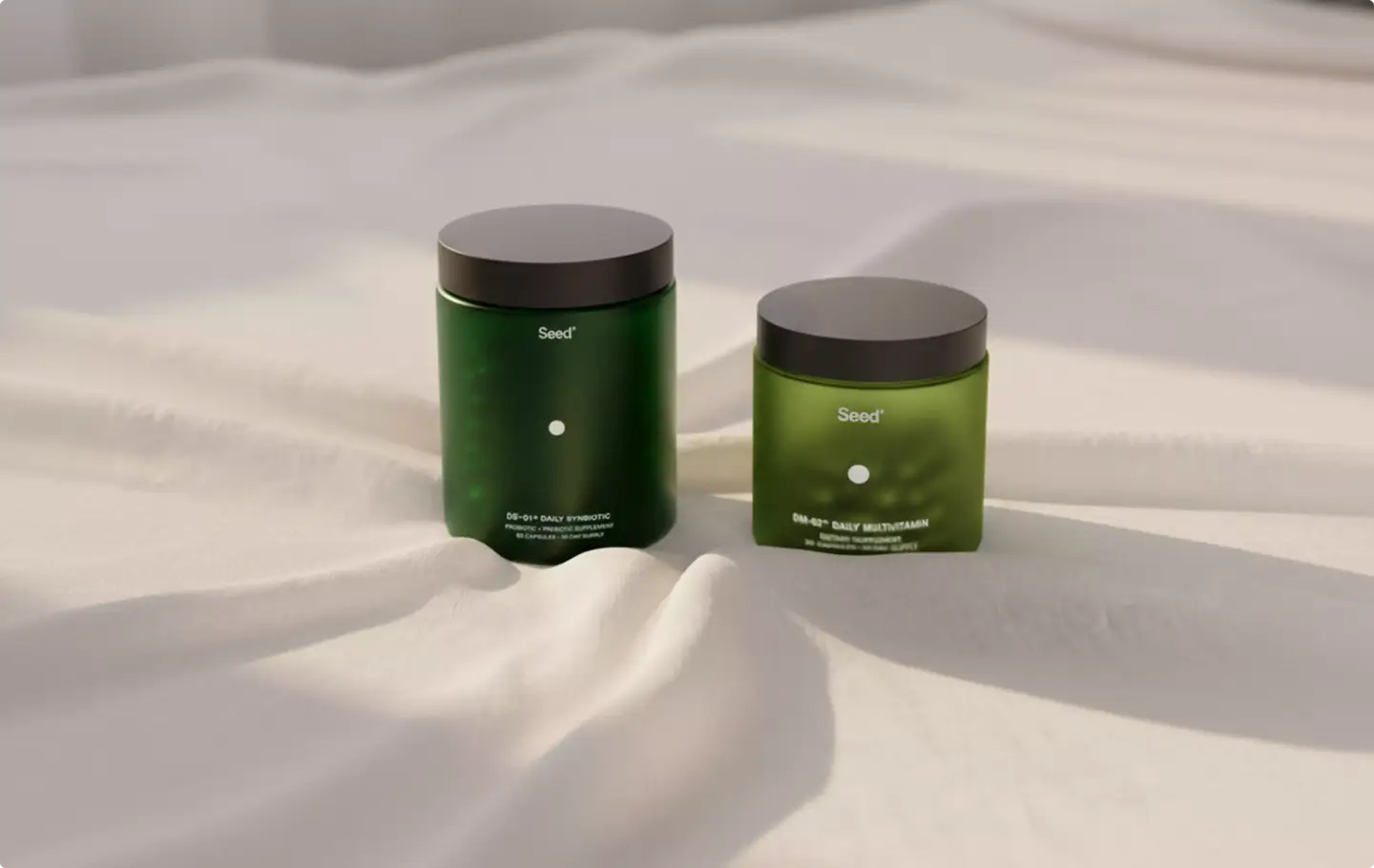 Two green supplement jars rendered on white fabric