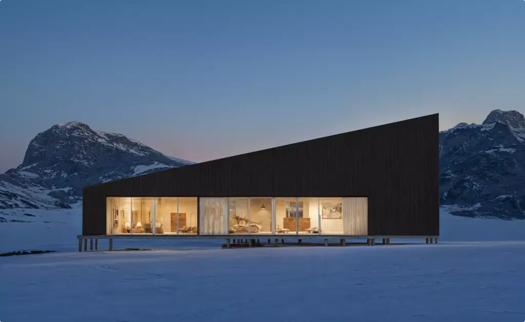 Winter night renders of a long modern cabin with glowing glass wall in a snowy mountain landscape