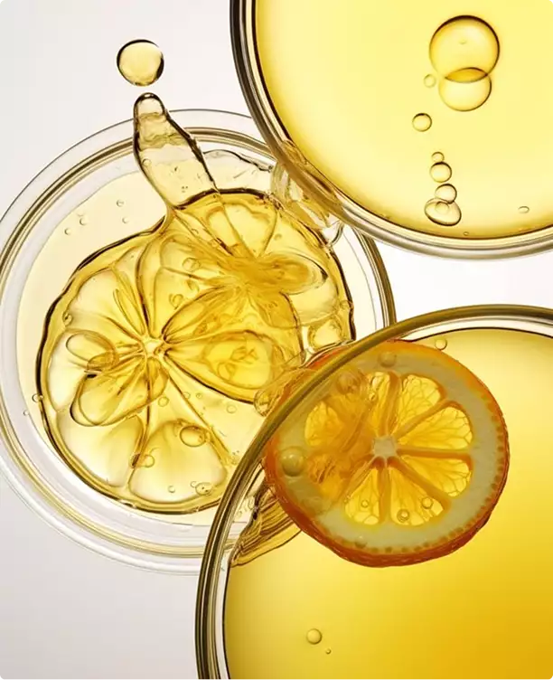 3D cosmetic golden liquid with citrus slices and bubbles in glass containers top view composition