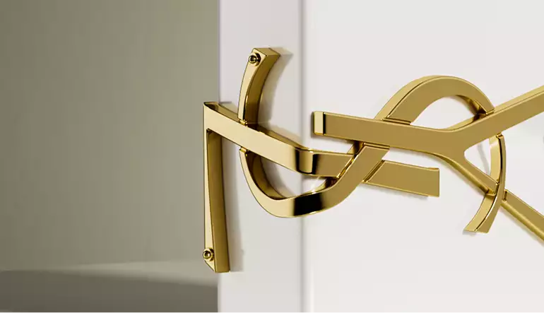 3D cosmetic gold logo detail on white perfume bottle close up with metallic finish and soft lighting