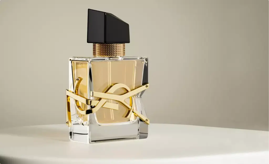 3D cosmetic perfume bottle with clear glass and gold detail on round pedestal neutral background