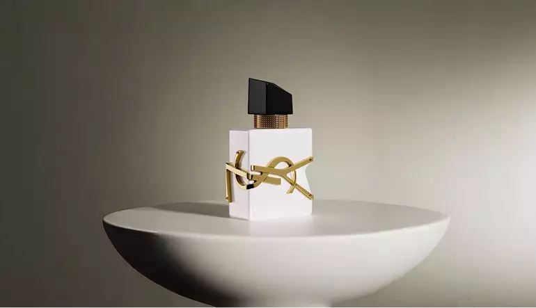 3D cosmetic white perfume bottle centered on round pedestal with soft lighting and shadow backdrop
