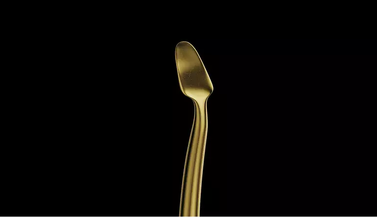 Dental tool head in 3D medical animation video on black background with smooth gold finish detail