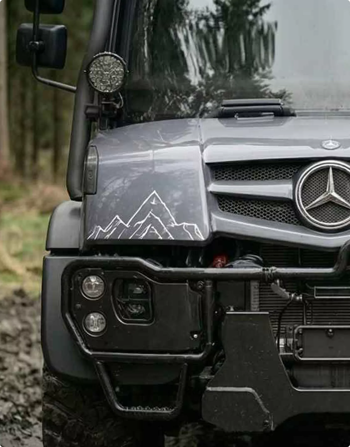 Mercedes off-road truck front in forest with mountain decal, Automotive Rendering Service