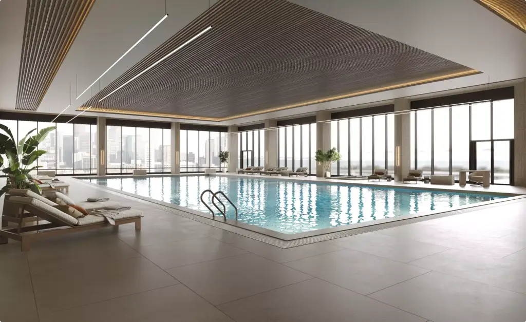 Indoor pool commercial gym design with lounge chairs, large windows, and city view