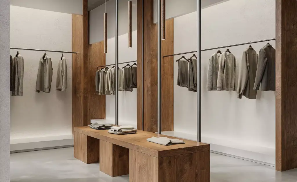 Fashion store interior design with wooden display table, hanging lights, and neatly arranged garments