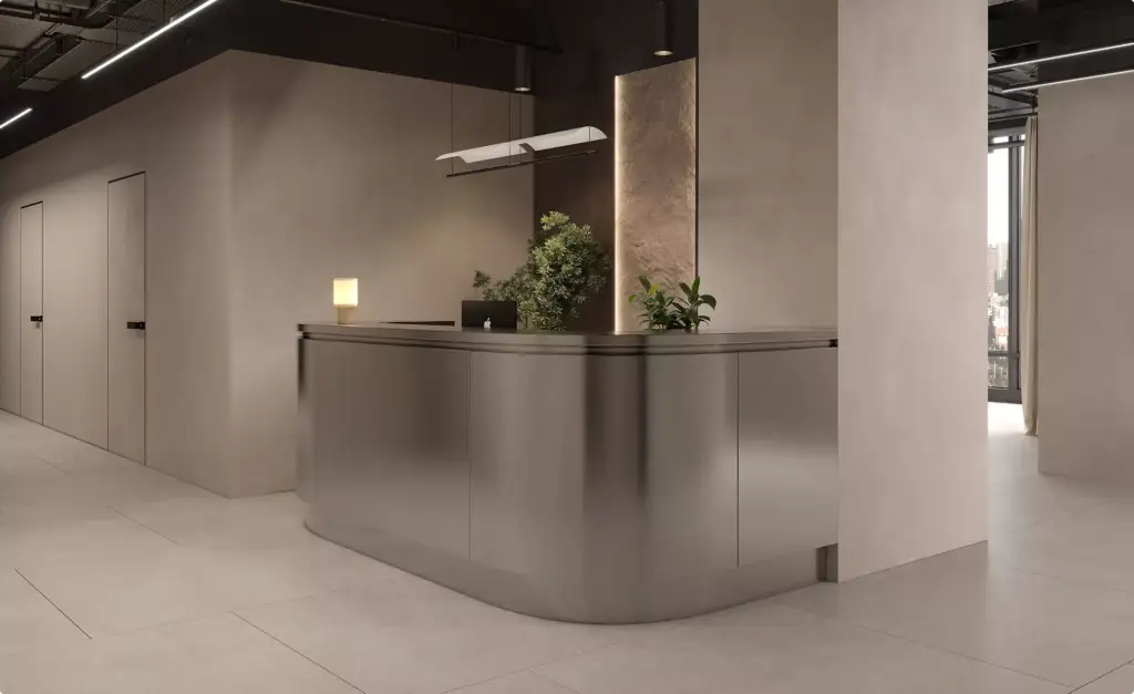 Reception desk fitness center architectural design with curved metal counter, plants, and minimal interior