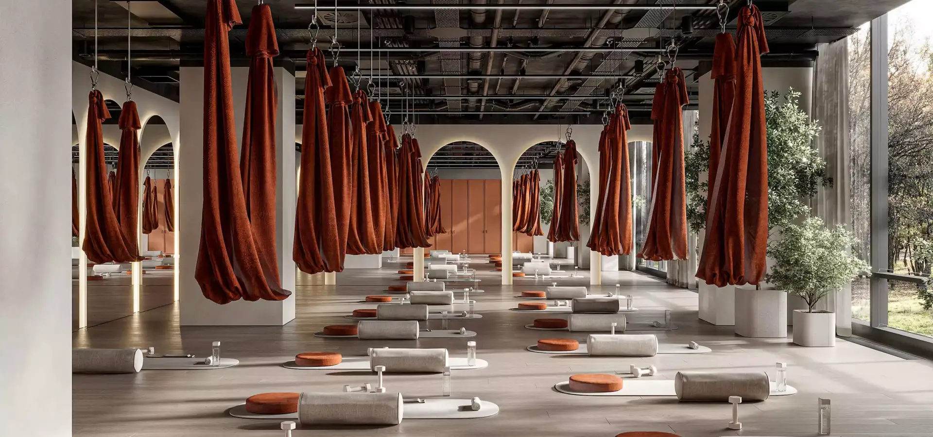 Symmetrical yoga space fitness center interior design with hammocks, arches, mats, and neutral tones