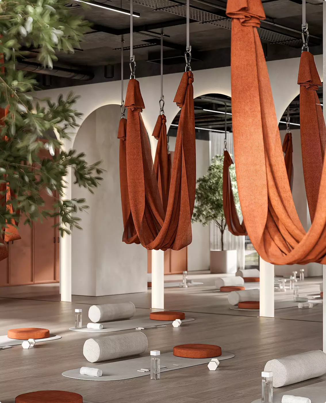 Aerial yoga space fitness club interior design with hanging hammocks, mats, and soft natural light