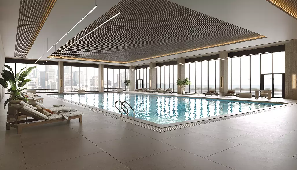 Indoor pool fitness club interior design with lounge chairs, large windows, and calm water