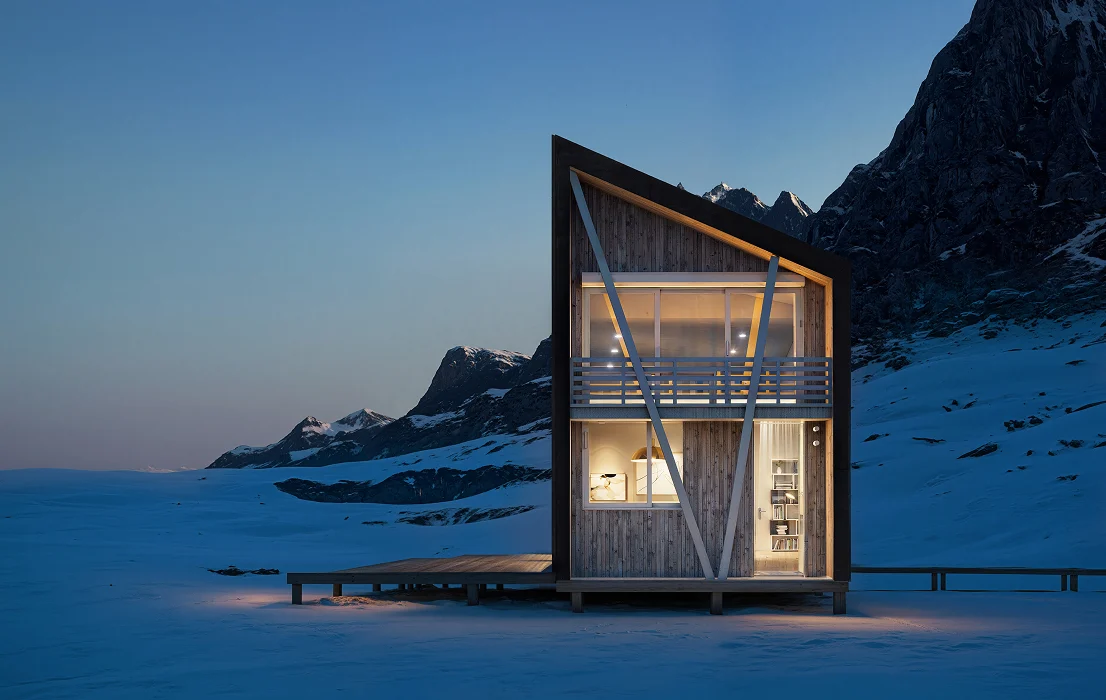Modern master plan cabin at night in snowy landscape with lit interior and mountain backdrop