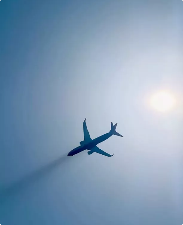 Gulfstream G450 aircraft design jet silhouette against bright sky with sun and contrail behind wings