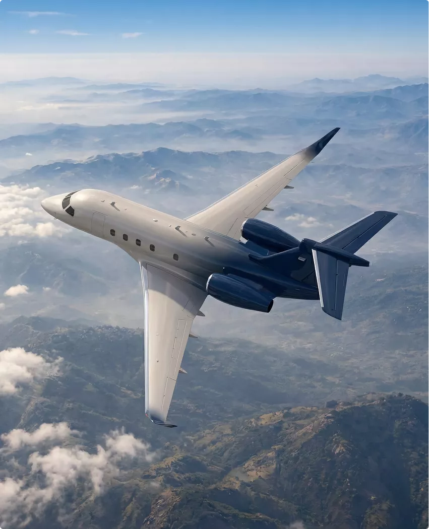 Gulfstream G450 designing aircraft jet banking above mountains with clouds below and twin rear engines