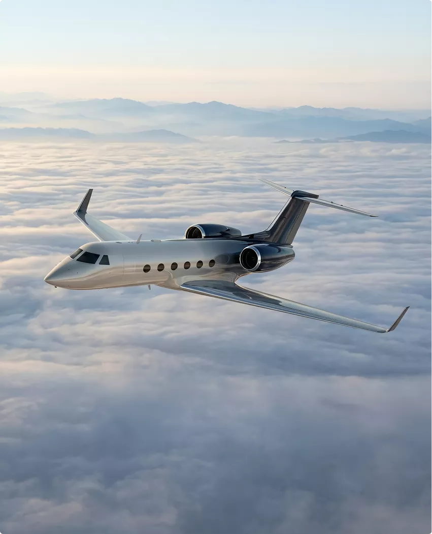 Gulfstream G450 designing aircraft jet cruising above cloud layer with distant mountains and sunlight