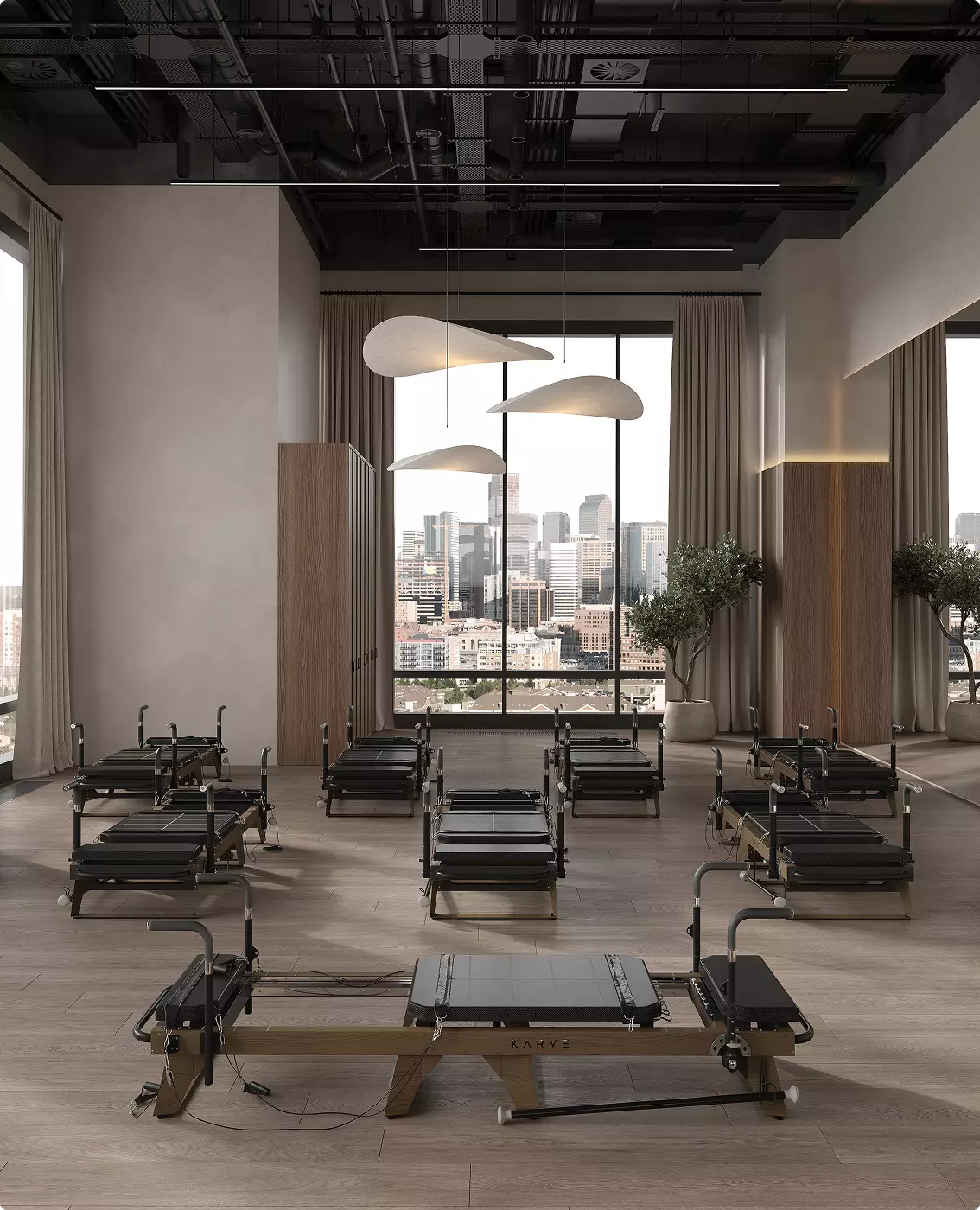 Pilates studio gym 3D visualization with reformer machines, wood floor, and city view