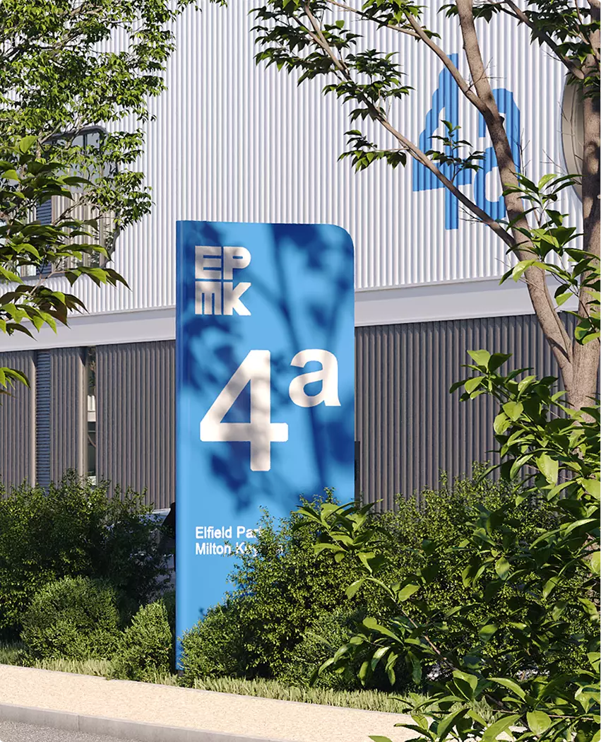 Photorealistic architectural rendering of blue 4a signage with trees in front of warehouse facade