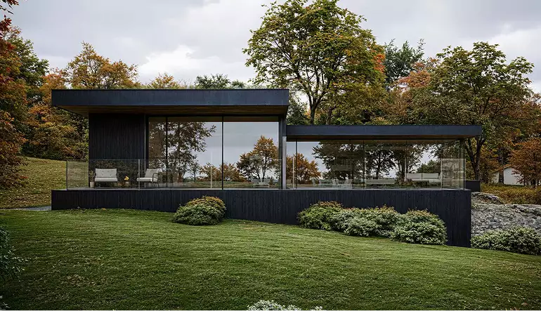Modern private house 3D rendering with horizontal layout, glass walls and sloped green lawn
