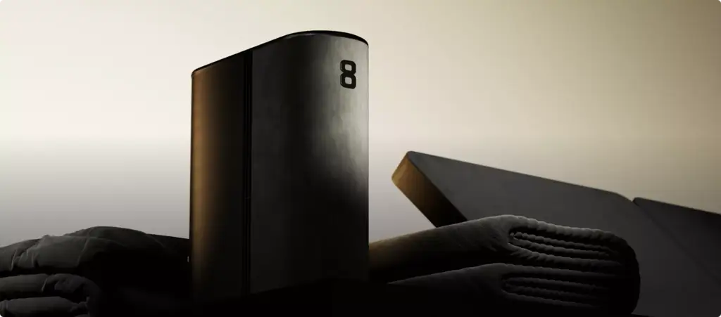 Matte black device with folded textiles in studio, product rendering with soft shadows