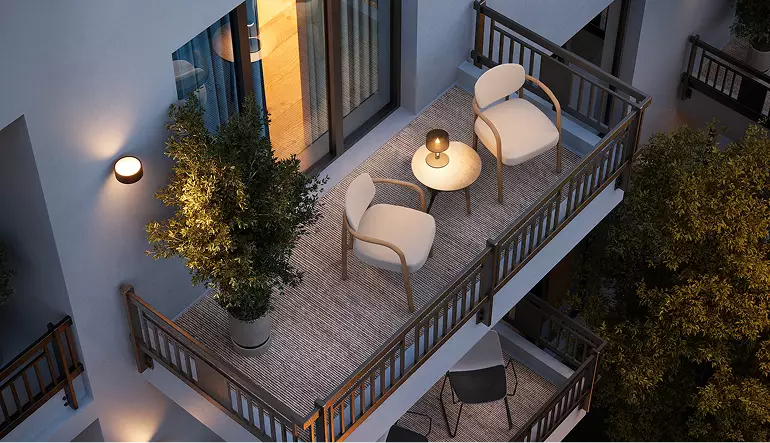 Real estate 3D exterior rendering balcony with chairs, table, plants, and warm lighting at night