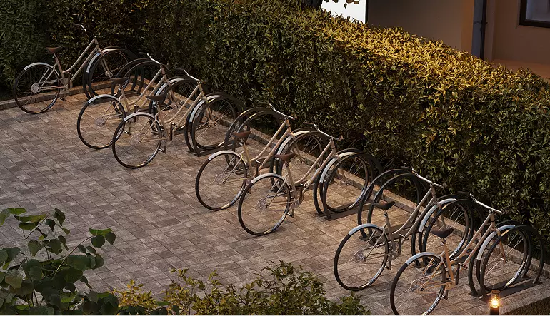 Real estate 3D exterior rendering bicycles parked along hedge on paved courtyard path