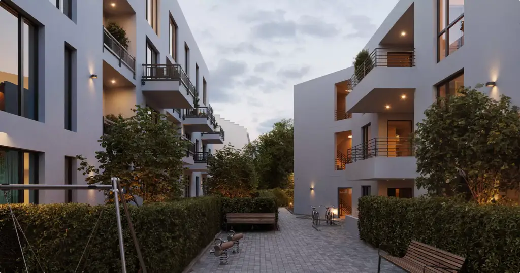 Real estate 3D exterior rendering courtyard between apartment buildings with trees, benches, and lights