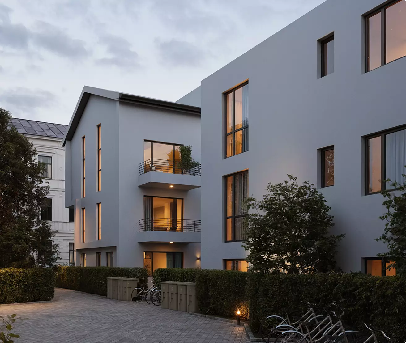 Best 3D Rendering Companies in the USA for Architectural Visualization & Real Estate in 2026 Modern residential building courtyard, 3D rendering company USA, bikes, hedges and windows