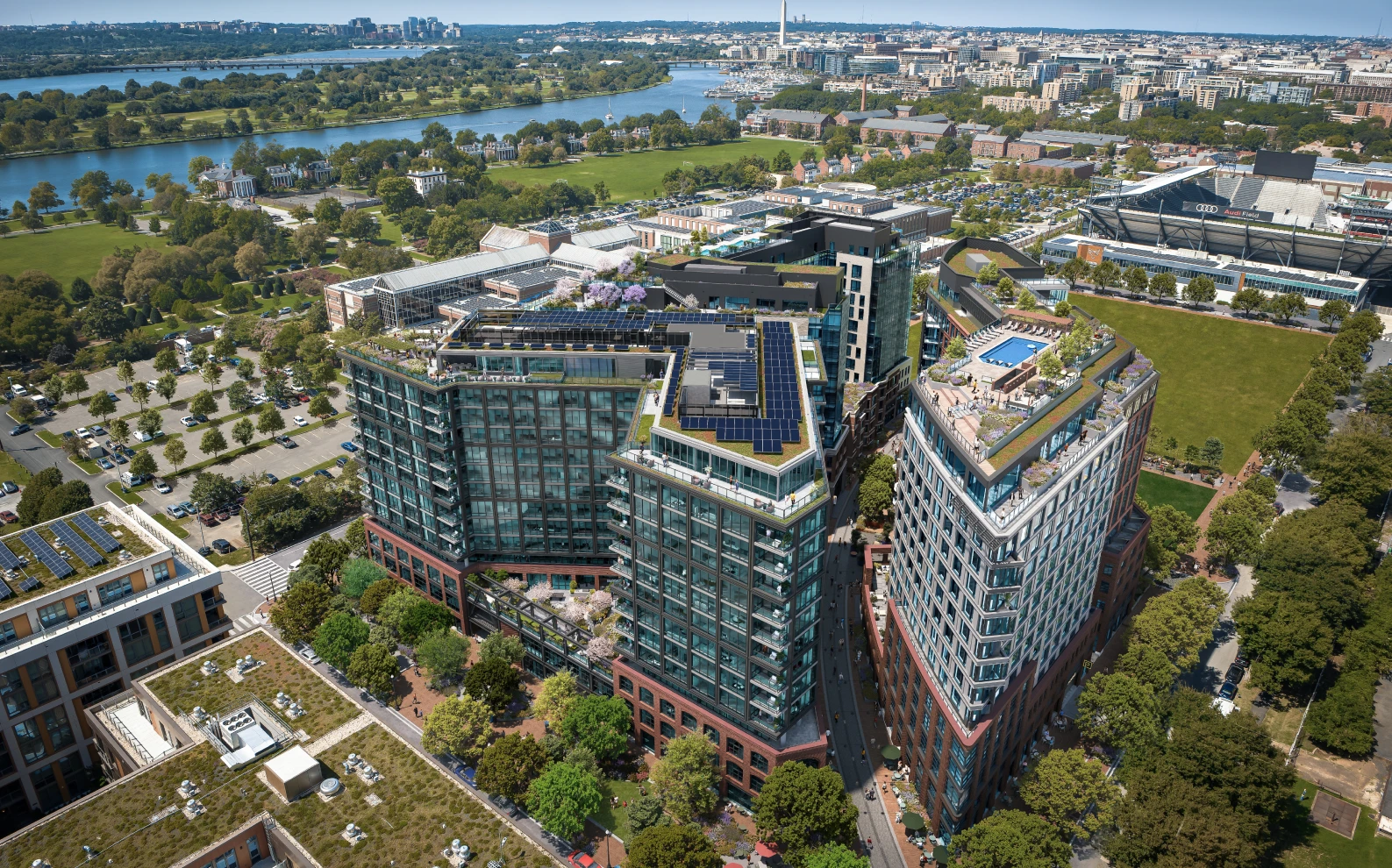 Best 3D Rendering Companies in the USA for Architectural Visualization & Real Estate in 2026 Urban mixed use buildings aerial, 3D rendering company USA, river, rooftops and city skyline