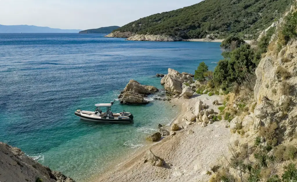 Small yacht tender in yacht rendering portfolio anchored beside rocky beach coastline